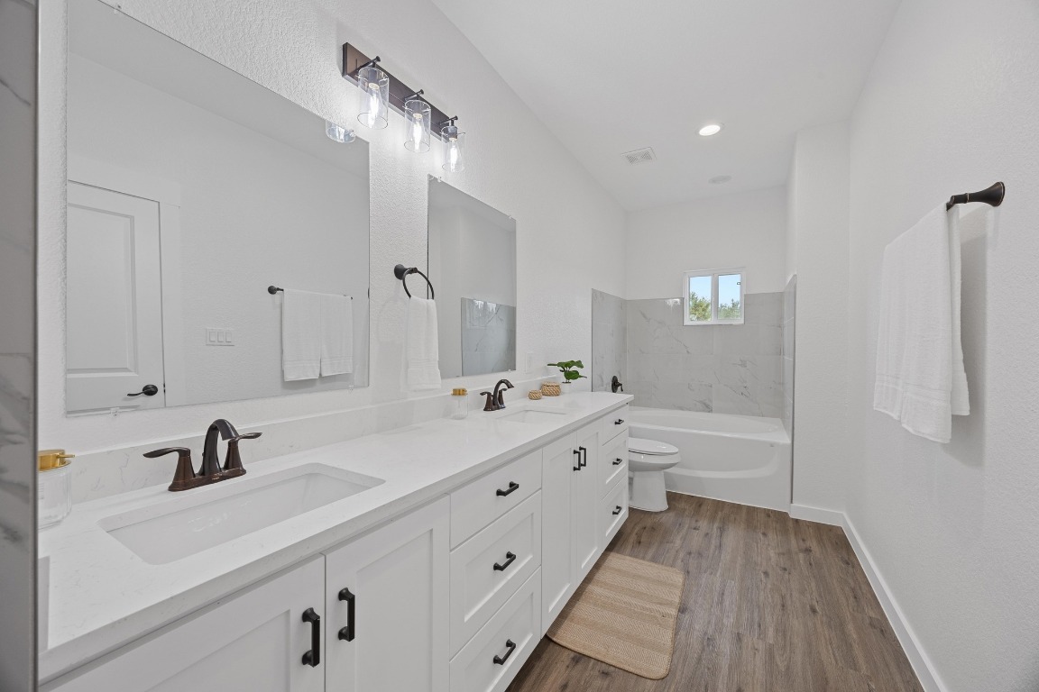 17701 Village Drive Dripping Springs, TX 78620 - Photo 20 of 36 a bathroom with a tub sink and mirror