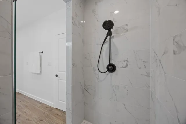 a view of a livingroom with wooden floor and a ceiling fan