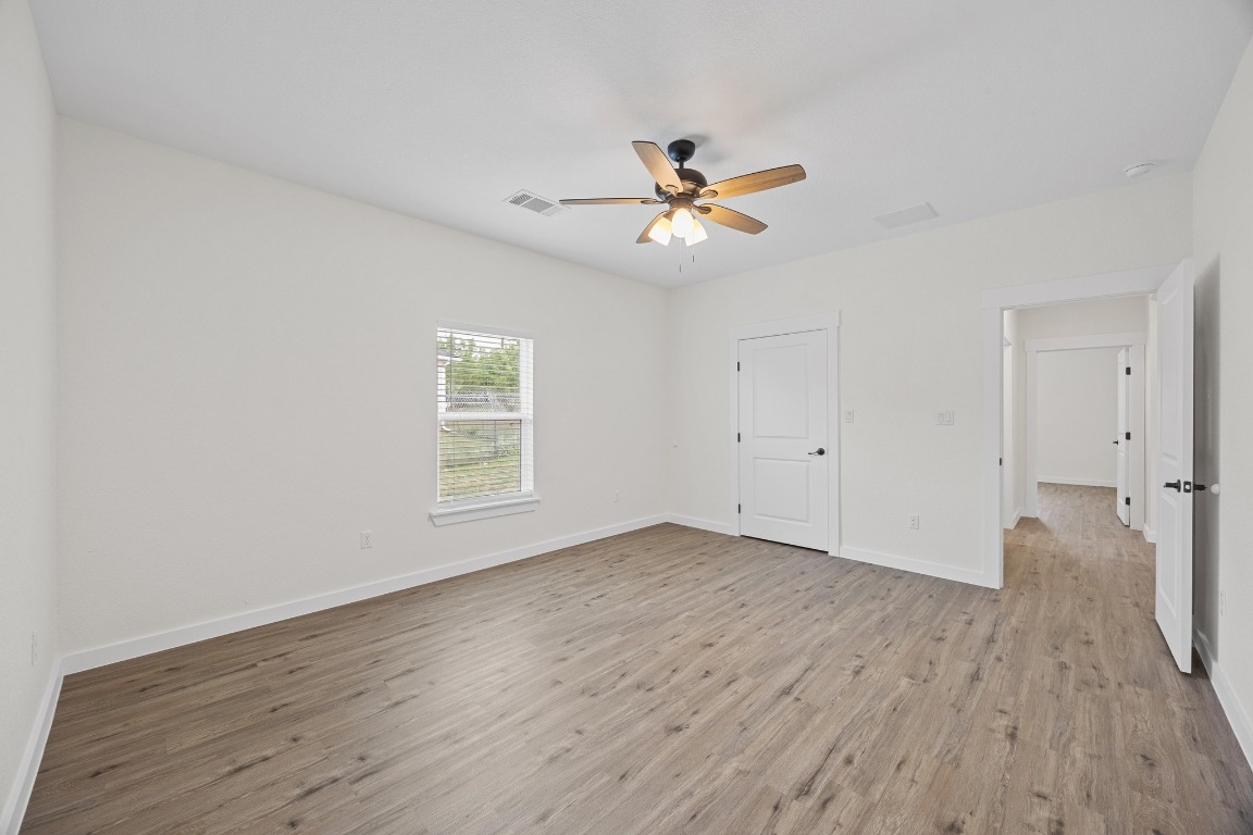 17701 Village Drive Dripping Springs, TX 78620 - Photo 28 of 36 a view of empty room with wooden floor and fan