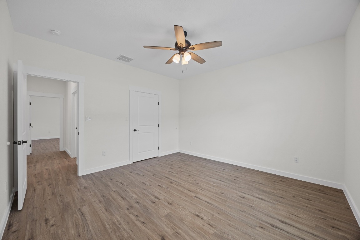 17701 Village Drive Dripping Springs, TX 78620 - Photo 30 of 36 a view of empty room with wooden floor