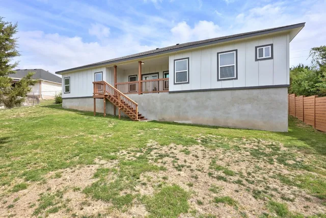 a view of a room with wooden floor and iron stairs
