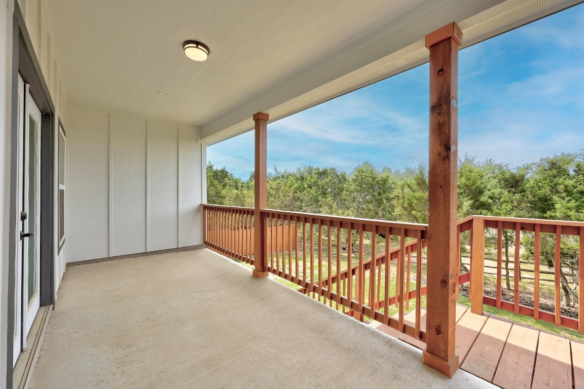 17701 Village Drive Dripping Springs, TX 78620 - Photo 35 of 36 a view of a room with wooden floor and iron stairs