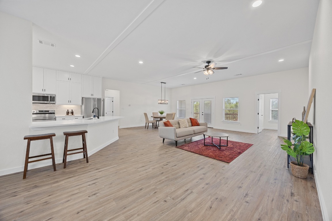 17701 Village Drive Dripping Springs, TX 78620 - Photo 9 of 36 a living room with furniture and wooden floor