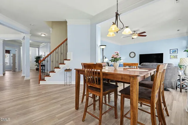 a view of a dining room with furniture wooden floor and chandelier