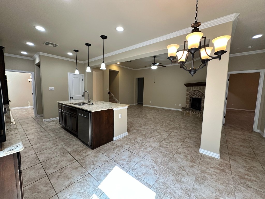 106 Shetland Lane Cedar Park, TX 78613 - Photo 11 of 31 a large kitchen with a chandelier and living room view