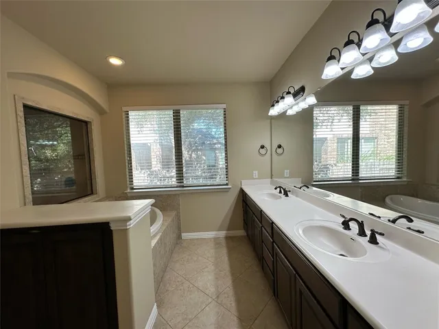 a bathroom with a double vanity sink mirror and double