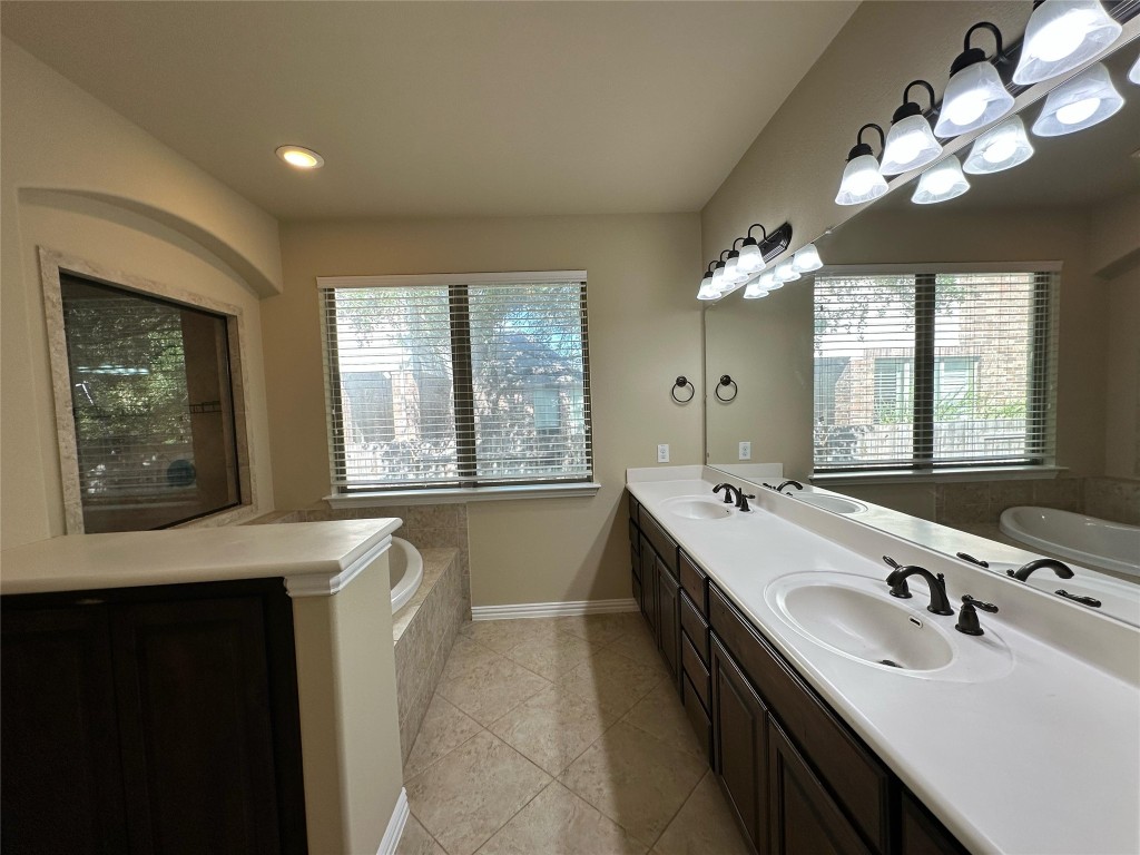 106 Shetland Lane Cedar Park, TX 78613 - Photo 16 of 31 a bathroom with a double vanity sink mirror and double