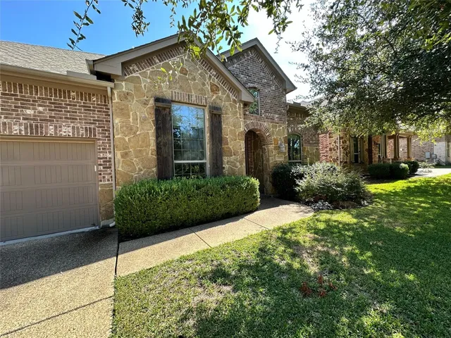 a view of a house with brick walls