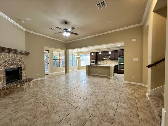 a view of a kitchen with a sink and a fireplace