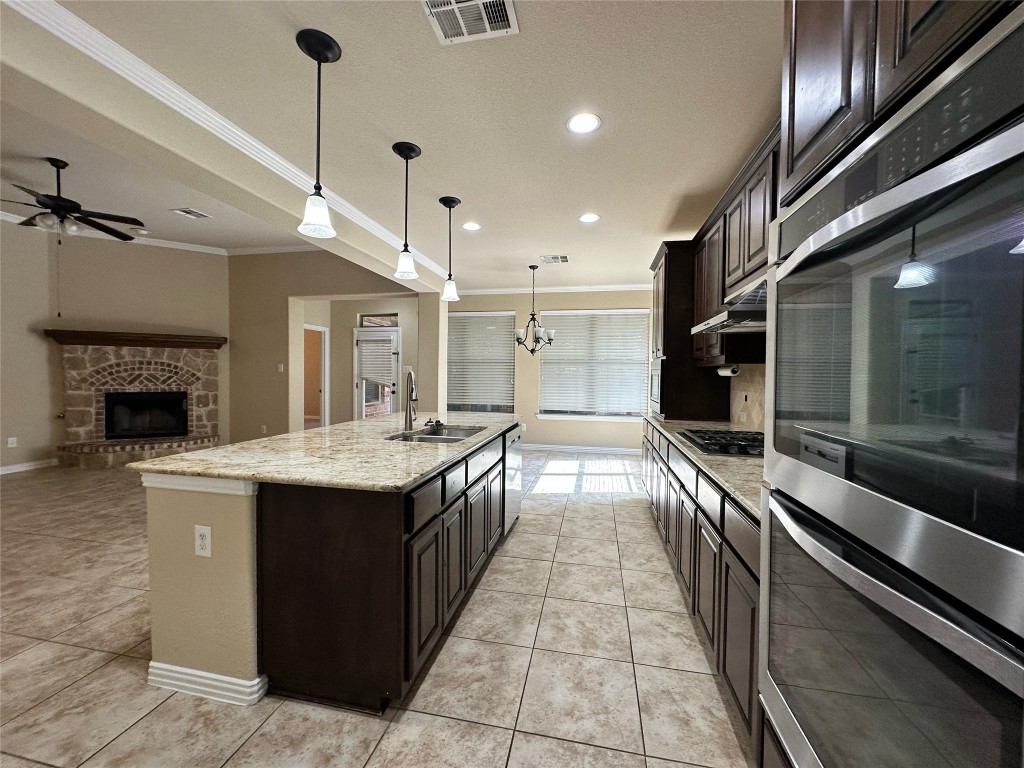 106 Shetland Lane Cedar Park, TX 78613 - Photo 10 of 31 a large kitchen with kitchen island a sink stainless steel appliances and cabinets
