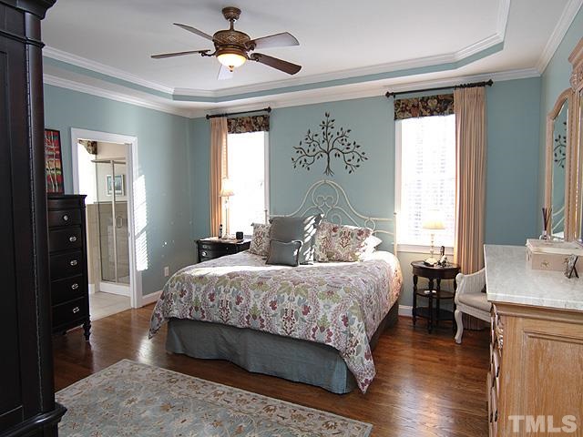 11618 John Allen Road Raleigh, NC 27614 - Photo 11 of 25 a bedroom with a large bed a chandelier and a window