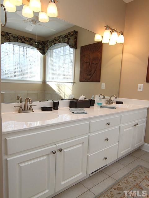 11618 John Allen Road Raleigh, NC 27614 - Photo 14 of 25 a bathroom with a double vanity sink mirror and window