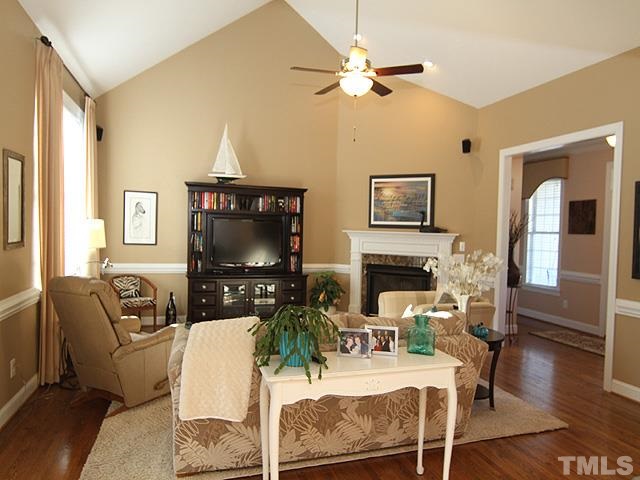 11618 John Allen Road Raleigh, NC 27614 - Photo 4 of 25 a living room with furniture a fireplace and a flat screen tv