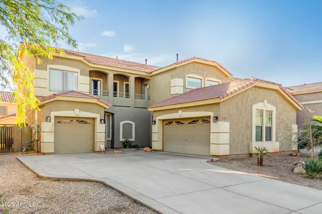 a front view of a house with a parking space