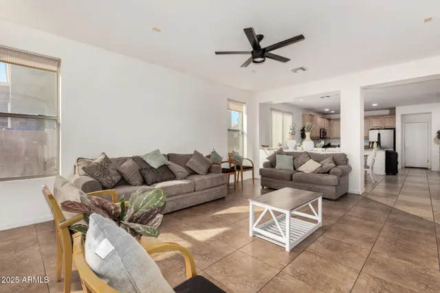 a living room with furniture and a ceiling fan