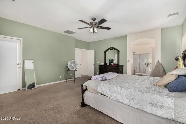 a bedroom with a bed and ceiling fan