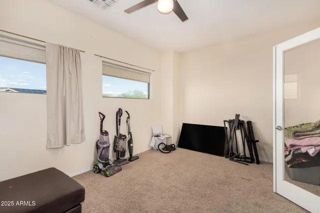 a room with gym equipment and a large mirror