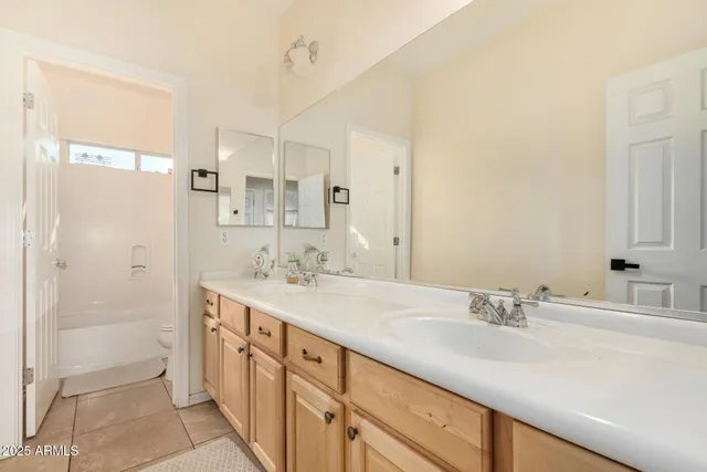 a bathroom with a sink double vanity and a mirror