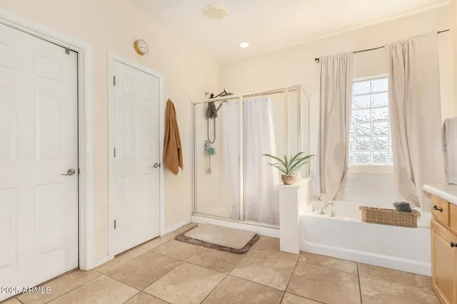 a bathroom with a shower a bathtub and a shower