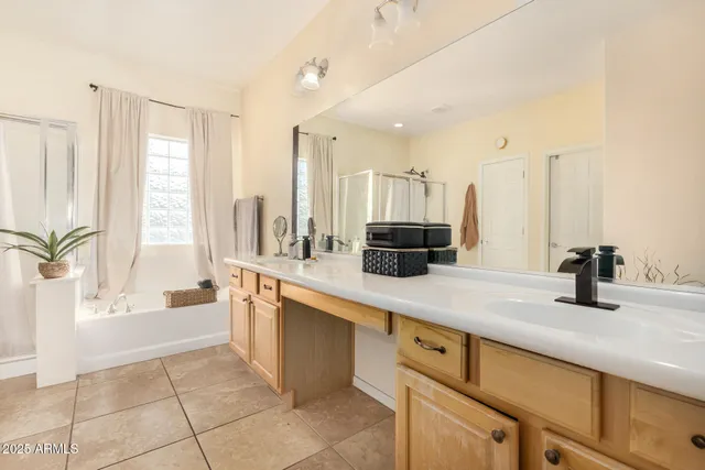 a large kitchen with kitchen island granite countertop a sink and white cabinets