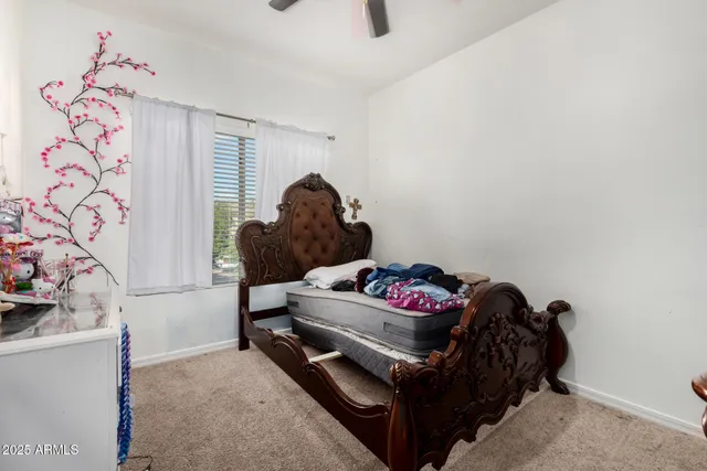 a bedroom with a bed and a window