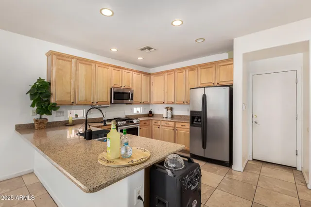 a kitchen with refrigerator and a counter top space