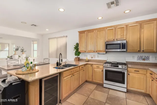 a kitchen with a sink stove and microwave
