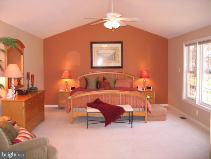 3648 Valley Road Ellicott City, MD 21042 - Photo 14 of 30 a bedroom with a bed and a chandelier