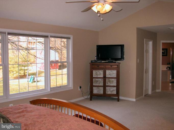 3648 Valley Road Ellicott City, MD 21042 - Photo 16 of 30 a living room with fireplace furniture and a flat screen tv