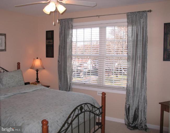 3648 Valley Road Ellicott City, MD 21042 - Photo 19 of 30 a bedroom with a bed and a chandelier