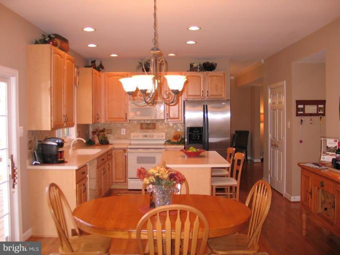 3648 Valley Road Ellicott City, MD 21042 - Photo 5 of 30 a dining room with furniture a chandelier and wooden floor