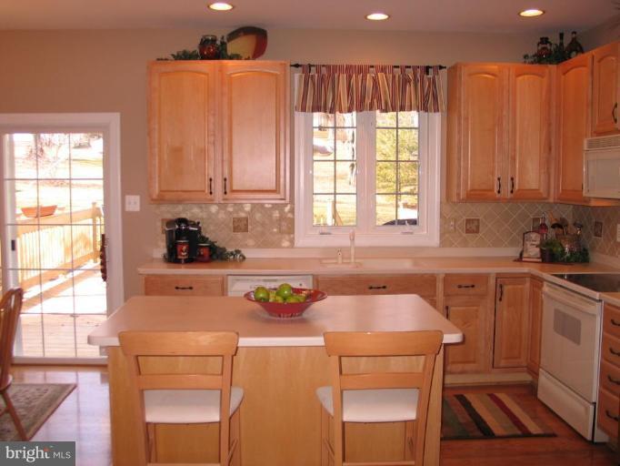 3648 Valley Road Ellicott City, MD 21042 - Photo 7 of 30 a kitchen with a table chairs and a window