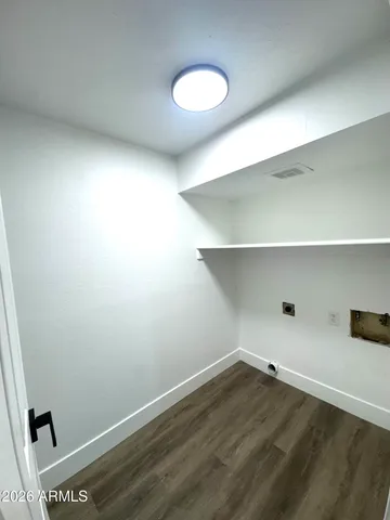 a view of a room with wooden floor and fan