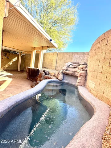 a view of a swimming pool with a lounge chairs