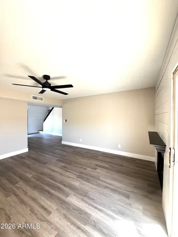 a view of a room with wooden floor and fan