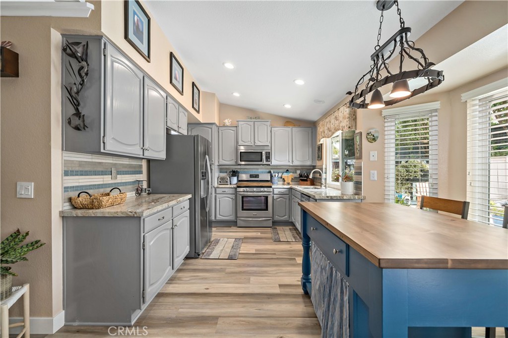 31141 Vía Gilberto Temecula, CA 92592 - Photo 15 of 39 a kitchen with granite countertop a sink a counter space stainless steel appliances and cabinets