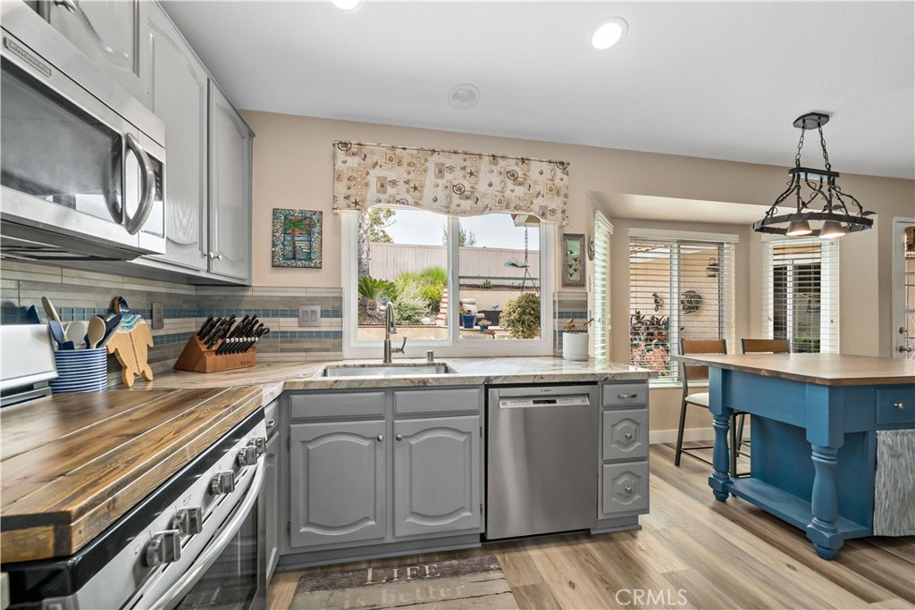 31141 Vía Gilberto Temecula, CA 92592 - Photo 16 of 39 a kitchen with a sink stove and cabinets