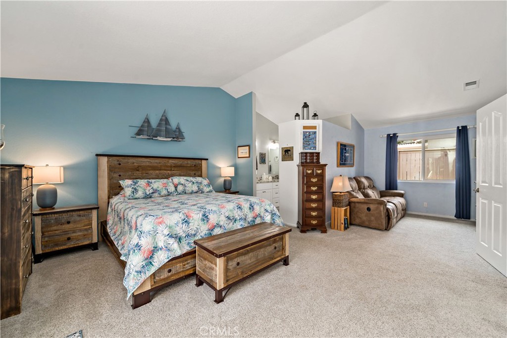 31141 Vía Gilberto Temecula, CA 92592 - Photo 19 of 39 a bedroom with a bed and a chandelier