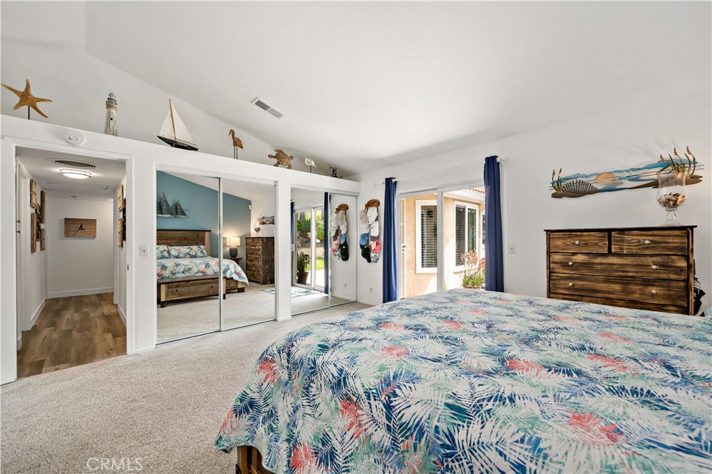 31141 Vía Gilberto Temecula, CA 92592 - Photo 21 of 39 a bedroom with a large bed and a large mirror