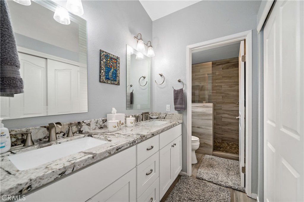 31141 Vía Gilberto Temecula, CA 92592 - Photo 23 of 39 a bathroom with a granite countertop sink mirror and a