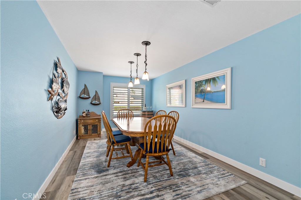 31141 Vía Gilberto Temecula, CA 92592 - Photo 26 of 39 a view of a dining room with furniture window and wooden floor