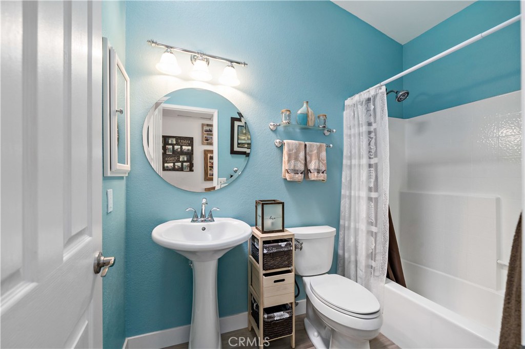 31141 Vía Gilberto Temecula, CA 92592 - Photo 29 of 39 a bathroom with a toilet a sink and a mirror