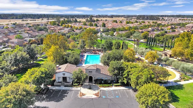 an aerial view of a houses with a yard