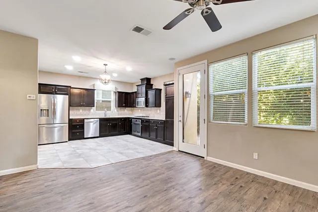 a view of kitchen with stainless steel appliances refrigerator oven microwave and stove
