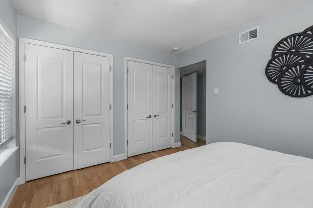 a bedroom with a bed and hallway