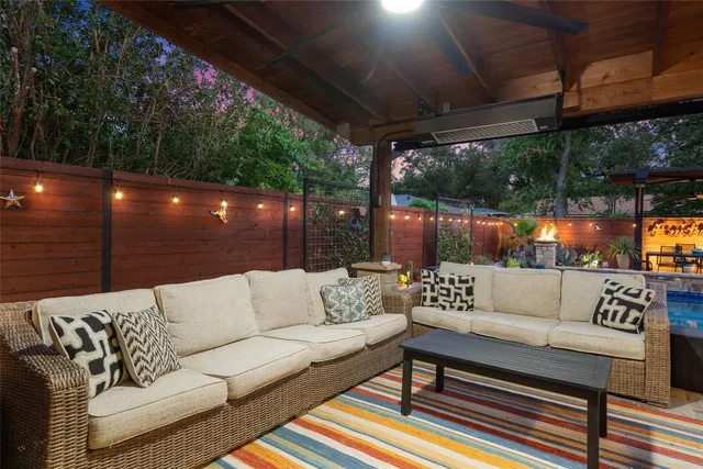 a outdoor living space with furniture and a fireplace