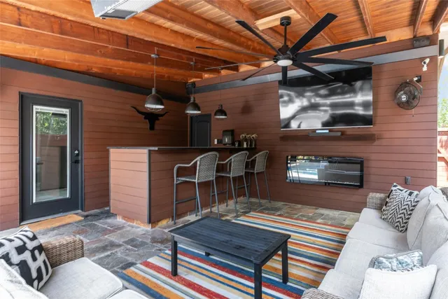 a outdoor living space with furniture and a fireplace