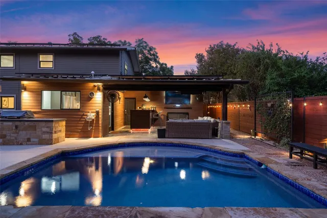 a view of a swimming pool with an outdoor seating