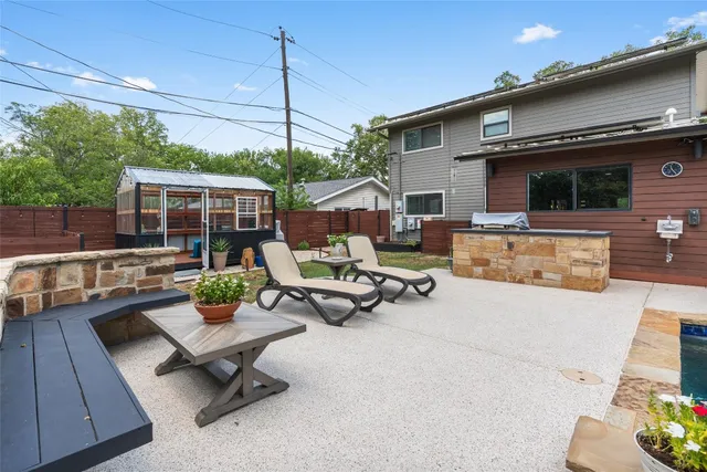a view of a patio with a table and chairs