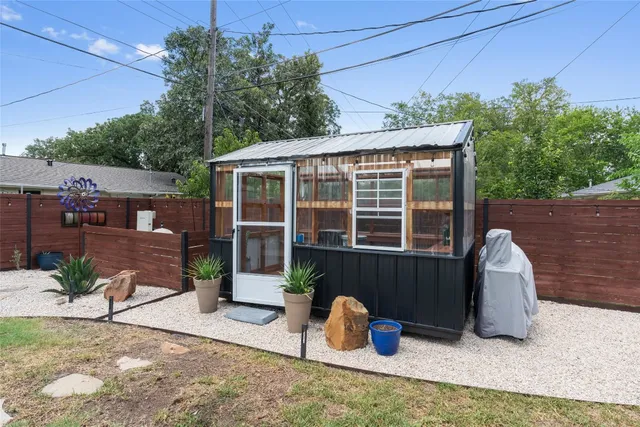 a view of backyard with outdoor seating and plants